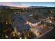 Panoramic aerial view of a luxury home at dusk, showcasing city lights and desert landscaping at 2749 Liberation Dr, Henderson, NV 89044