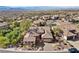 Aerial view showcases a tile roof home with mature trees and desert landscaping at 2749 Liberation Dr, Henderson, NV 89044