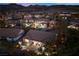 Stunning aerial view of a meticulously maintained home in a tranquil community with mountain views at twilight at 2749 Liberation Dr, Henderson, NV 89044