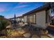 Paver patio with outdoor seating, lush landscaping and outdoor lighting, perfect for evening relaxation at 2749 Liberation Dr, Henderson, NV 89044