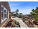 Lush backyard featuring a patio, mature landscaping, and distant views at 2749 Liberation Dr, Henderson, NV 89044