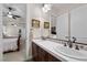Shared bathroom featuring dual sinks, tiled backsplash, and bedroom access at 2749 Liberation Dr, Henderson, NV 89044