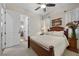 Comfortable bedroom with a wooden bed frame, soft lighting, and floral accents at 2749 Liberation Dr, Henderson, NV 89044