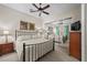 Cozy bedroom with mirrored closet doors, ceiling fan, and neutral decor at 2749 Liberation Dr, Henderson, NV 89044