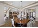 Spacious dining area with a fireplace, hardwood table, and views of the kitchen at 2749 Liberation Dr, Henderson, NV 89044