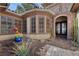 Inviting home exterior with a covered entrance, stone accents, and well-maintained landscaping at 2749 Liberation Dr, Henderson, NV 89044