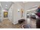 Spacious hallway leading to an open-concept living area, featuring tile flooring and ample natural light at 2749 Liberation Dr, Henderson, NV 89044