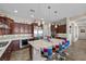 Modern kitchen with stainless steel appliances, a large island, and colorful bar stools at 2749 Liberation Dr, Henderson, NV 89044