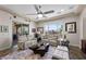 Bright living room with two sofas, patterned rug, a ceiling fan and patio access at 2749 Liberation Dr, Henderson, NV 89044