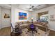 Cozy living room featuring comfortable seating, neutral decor, and view to the outdoor patio at 2749 Liberation Dr, Henderson, NV 89044