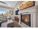 Comfortable living room featuring a fireplace and large window letting in natural light at 2749 Liberation Dr, Henderson, NV 89044