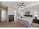Spacious main bedroom with a king bed, dresser, and bathroom access at 2749 Liberation Dr, Henderson, NV 89044
