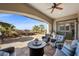 Spacious covered patio with ample seating, ceiling fan, and outdoor dining area overlooking landscaped yard at 2749 Liberation Dr, Henderson, NV 89044