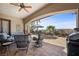 Comfortable outdoor patio area with beautiful landscaping, seating, and a ceiling fan at 2749 Liberation Dr, Henderson, NV 89044