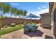 Outdoor patio area featuring pavers, artificial grass, and a dining set, creating a perfect space for entertaining at 2915 Moulton Crest Ave, Henderson, NV 89044