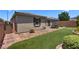 Landscaped backyard featuring pavers, artificial turf, and a dining area for enjoying outdoor relaxation and gatherings at 2915 Moulton Crest Ave, Henderson, NV 89044