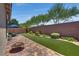 Backyard features pavers, artificial turf, a fire pit and desert landscaping, creating a serene outdoor oasis at 2915 Moulton Crest Ave, Henderson, NV 89044