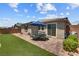 A backyard with pavers, artificial grass, a patio set and nice landscaping providing an inviting outdoor living space at 2915 Moulton Crest Ave, Henderson, NV 89044