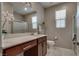 This modern bathroom features a sleek vanity, tiled floors, and a glass-enclosed shower at 2915 Moulton Crest Ave, Henderson, NV 89044