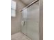This bathroom showcases a frameless glass shower with a tiled base, complemented by neutral wall colors at 2915 Moulton Crest Ave, Henderson, NV 89044