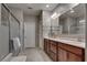 Bathroom with double vanity, wood cabinets, shower, and tile flooring at 2915 Moulton Crest Ave, Henderson, NV 89044