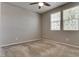 Neutral bedroom featuring carpet flooring, a ceiling fan, and bright windows, providing a cozy and inviting atmosphere at 2915 Moulton Crest Ave, Henderson, NV 89044