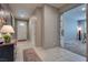 Entryway features tile floors, a white front door, and open access to a carpeted living space with a sliding door at 2915 Moulton Crest Ave, Henderson, NV 89044