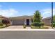 Charming single-story home with a well-manicured front yard, desert landscaping, and a tile roof under a blue sky at 2915 Moulton Crest Ave, Henderson, NV 89044