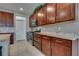 Granite countertops, stainless steel appliances, and rich dark wood cabinetry in kitchen at 2915 Moulton Crest Ave, Henderson, NV 89044