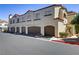 Exterior view of townhome featuring private garages and desert landscaping at 2975 Bluegrass Ln # 811, Henderson, NV 89074