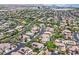 Scenic aerial view showcasing homes with neatly manicured lawns, and lush trees, complemented by nearby mountains at 3000 Hammerwood Dr, Las Vegas, NV 89135