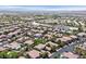 Breathtaking aerial view featuring a meticulously planned community, complete with pools, lush trees, and schools at 3000 Hammerwood Dr, Las Vegas, NV 89135