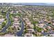 Picturesque aerial shot of a residential area with winding roads, solar panels, and lush trees at 3000 Hammerwood Dr, Las Vegas, NV 89135