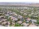 Aerial view showing a beautiful neighborhood with well-maintained homes and lush trees, enhanced by a mountain backdrop at 3000 Hammerwood Dr, Las Vegas, NV 89135