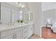 Bright bathroom with double sink vanity, white cabinets, and access to bedroom at 3000 Hammerwood Dr, Las Vegas, NV 89135