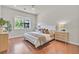 Well-lit bedroom with wood floors, neutral colors, and window view of outdoor gazebo at 3000 Hammerwood Dr, Las Vegas, NV 89135