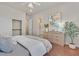 Comfortable bedroom with wood floors, ceiling fan, ensuite bathroom, and closet at 3000 Hammerwood Dr, Las Vegas, NV 89135