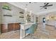 Open-concept kitchen bar boasts pendant lighting, a wine rack, and stylish stone-look floors at 3000 Hammerwood Dr, Las Vegas, NV 89135