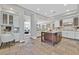 Modern kitchen with white cabinetry, an island, and stone-look floors at 3000 Hammerwood Dr, Las Vegas, NV 89135
