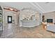 Open concept living area with stone floors, arched entryways, and fireplace at 3000 Hammerwood Dr, Las Vegas, NV 89135