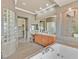 Elegant main bathroom featuring soaking tub, natural light, and stylish decor at 3000 Hammerwood Dr, Las Vegas, NV 89135