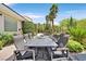 Elegant outdoor dining area perfect for hosting gatherings with a view of the pool and lush landscaping at 3000 Hammerwood Dr, Las Vegas, NV 89135
