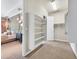 Spacious walk-in closet with built-in shelving, carpeted floors, and access to the main bedroom at 3000 Hammerwood Dr, Las Vegas, NV 89135
