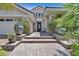Inviting walkway leading to the front door, surrounded by lush landscaping and potted plants at 3000 Hammerwood Dr, Las Vegas, NV 89135