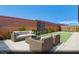 Private backyard oasis with stylish outdoor furniture, a modern water feature, and lush landscaping at 329 Blossom Wind St # Lot 14, Henderson, NV 89015