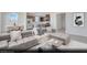 Open-concept living room and kitchen area with modern furnishings and stainless steel appliances at 329 Blossom Wind St # Lot 14, Henderson, NV 89015