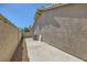 The backyard boasts a private concrete patio with an adjacent privacy wall, perfect for outdoor enjoyment at 335 Simon Bolivar Dr, Henderson, NV 89014