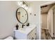 This is a modern bathroom vanity featuring a round mirror, elegant lighting, and stylish fixtures at 335 Simon Bolivar Dr, Henderson, NV 89014