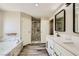 Well-lit bathroom with a dual sink vanity, modern lighting, and a marble tiled walk-in shower at 335 Simon Bolivar Dr, Henderson, NV 89014