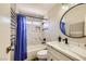 The remodeled bathroom features sleek tiling, modern fixtures, and a stylish vanity, creating a serene and modern aesthetic at 335 Simon Bolivar Dr, Henderson, NV 89014